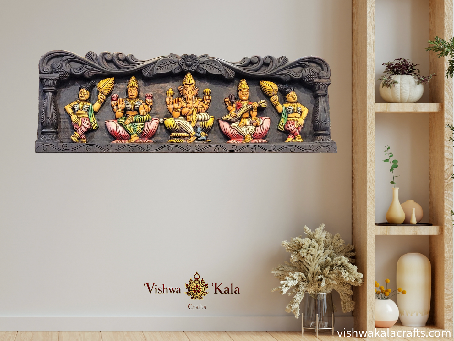 Decorative wall art with colorful figures on a white wall, featuring the 'Vishwa Kala Crafts' brand.
