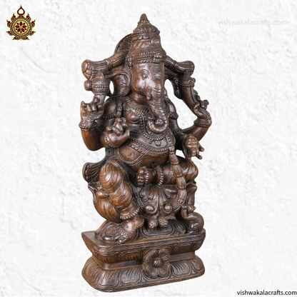 Handcrafted Wooden Ganesha Statue in Traditional Temple Setting